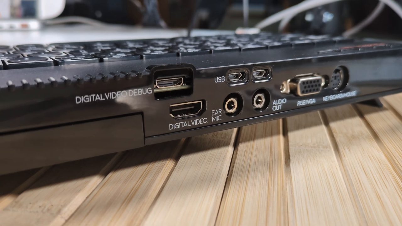 The rear of the Next with the Pi's DIGITAL VIDEO DEBUG port and two micro USB ports above the Next's own HDMI, EAR/MIC, audio, and VGA ports
