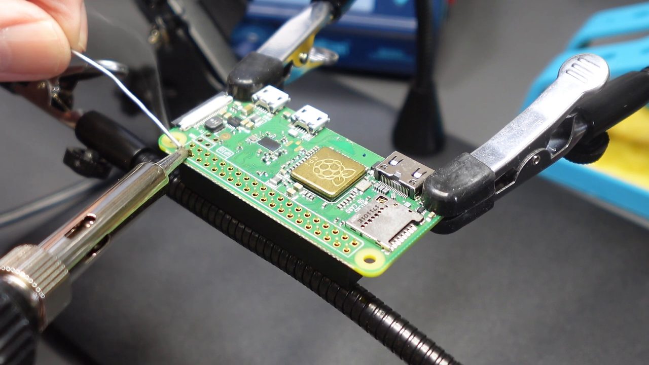 Soldering the header pins with the Pi Zero held in magnetic helping hands